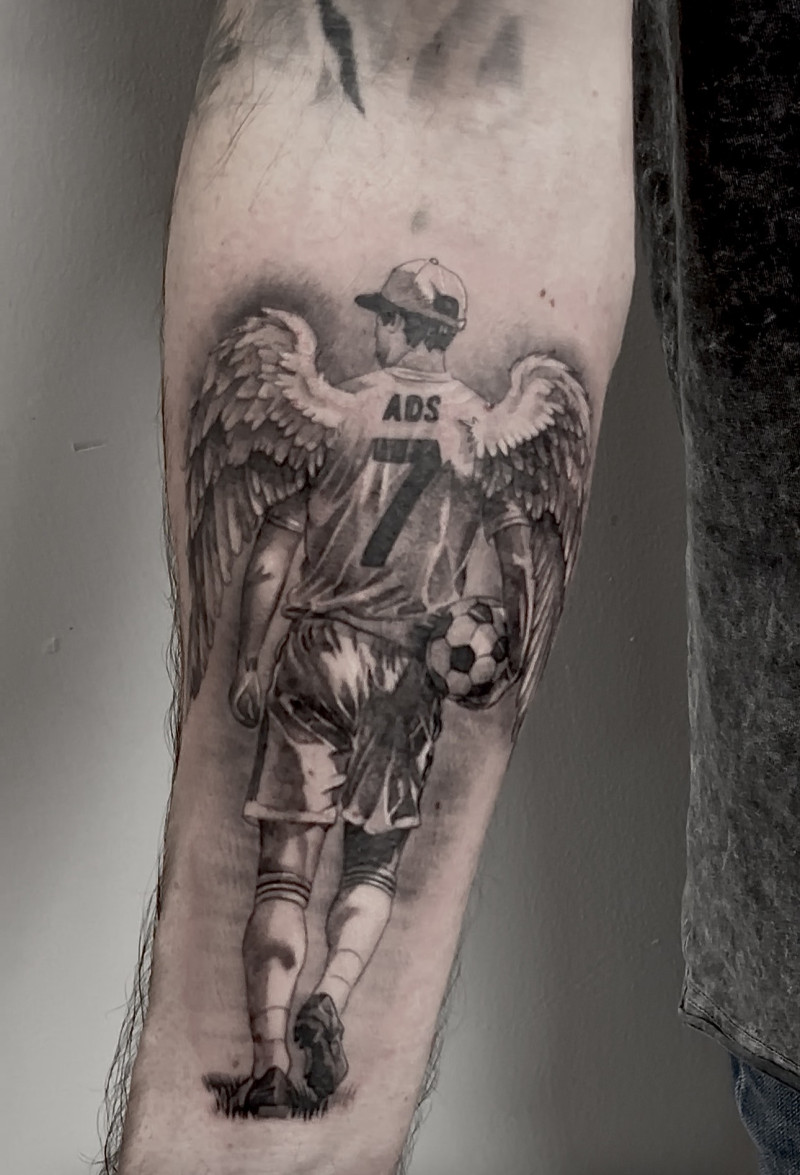 Memorial Angel Football Player Forearm Tattoo by Esther – Black & Grey | Unicorn Tattoo Art Collective, Ashford Surrey