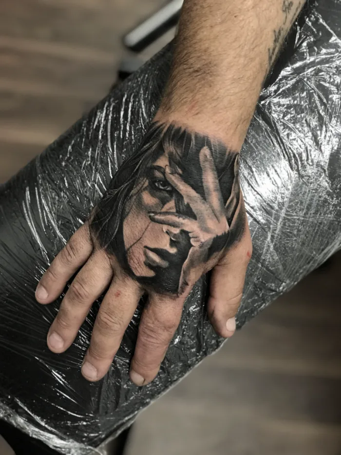 Black and grey realistic female portrait hand tattoo by Esther, Unicorn Tattoo Art Collective, Ashford Surrey