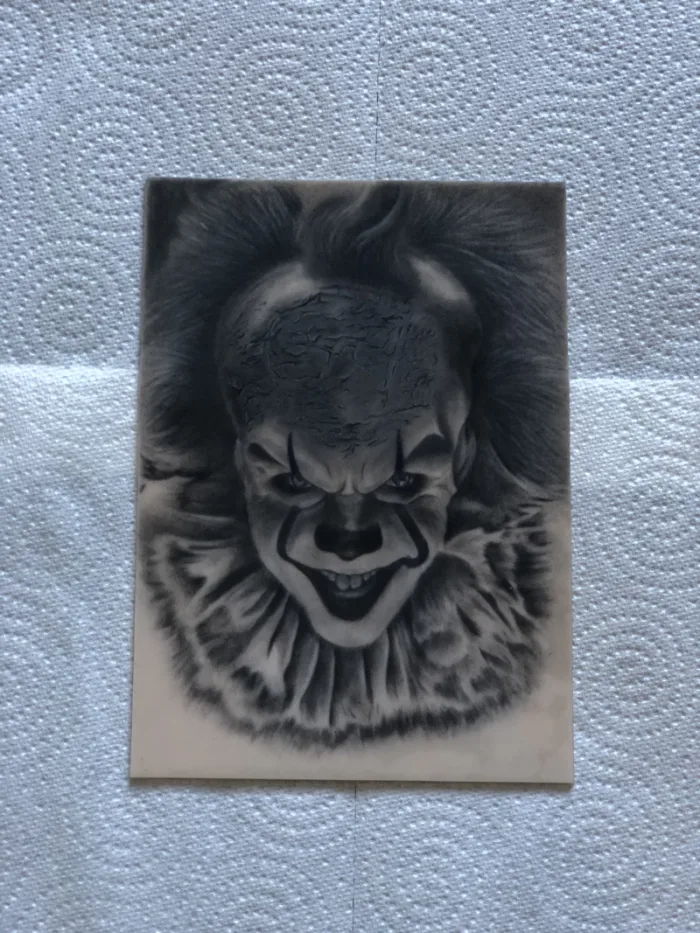 Realistic black and grey Pennywise IT clown portrait drawing on practice skin by Chris, Unicorn Tattoo Art Collective, Ashford Surrey