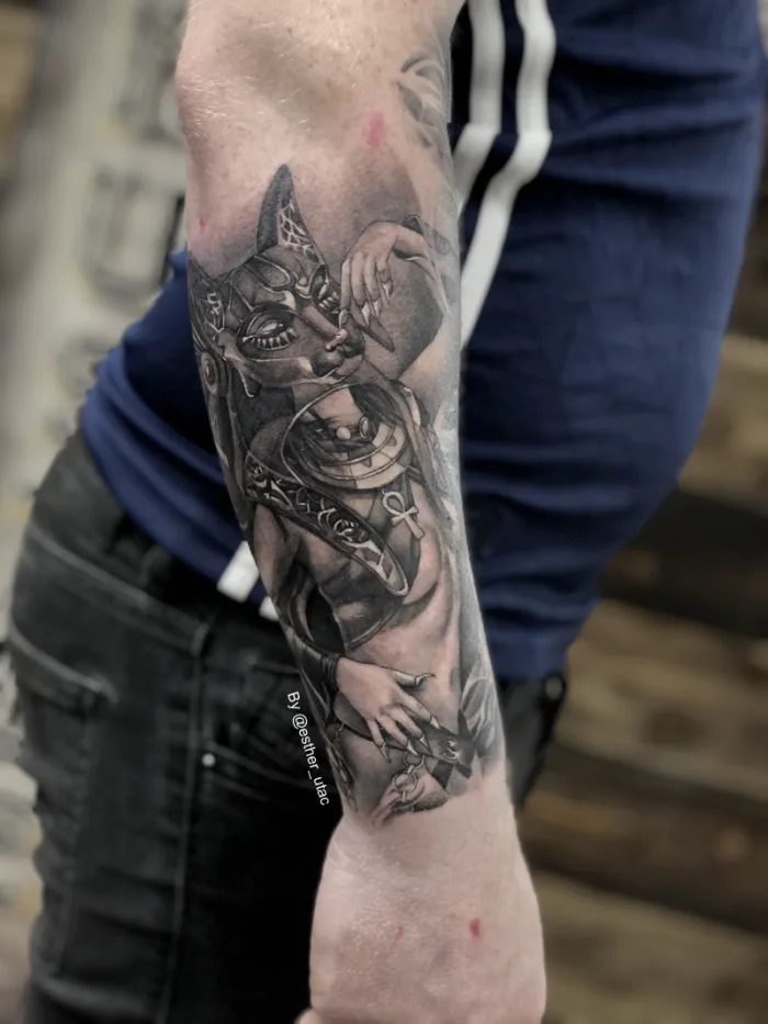 Black and grey Egyptian goddess Bastet and Anubis forearm sleeve tattoo in progress by Esther, Unicorn Tattoo Art Collective, Ashford Surrey