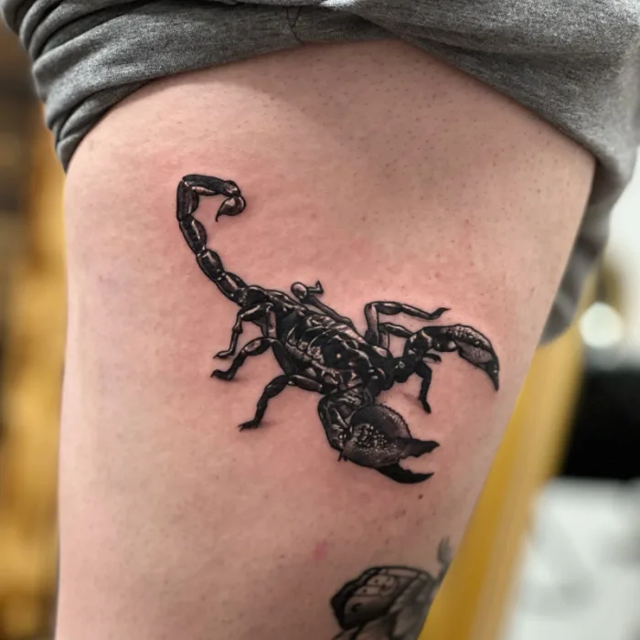 Realistic black and grey scorpion thigh tattoo by Esther, Unicorn Tattoo Art Collective, Ashford Surrey