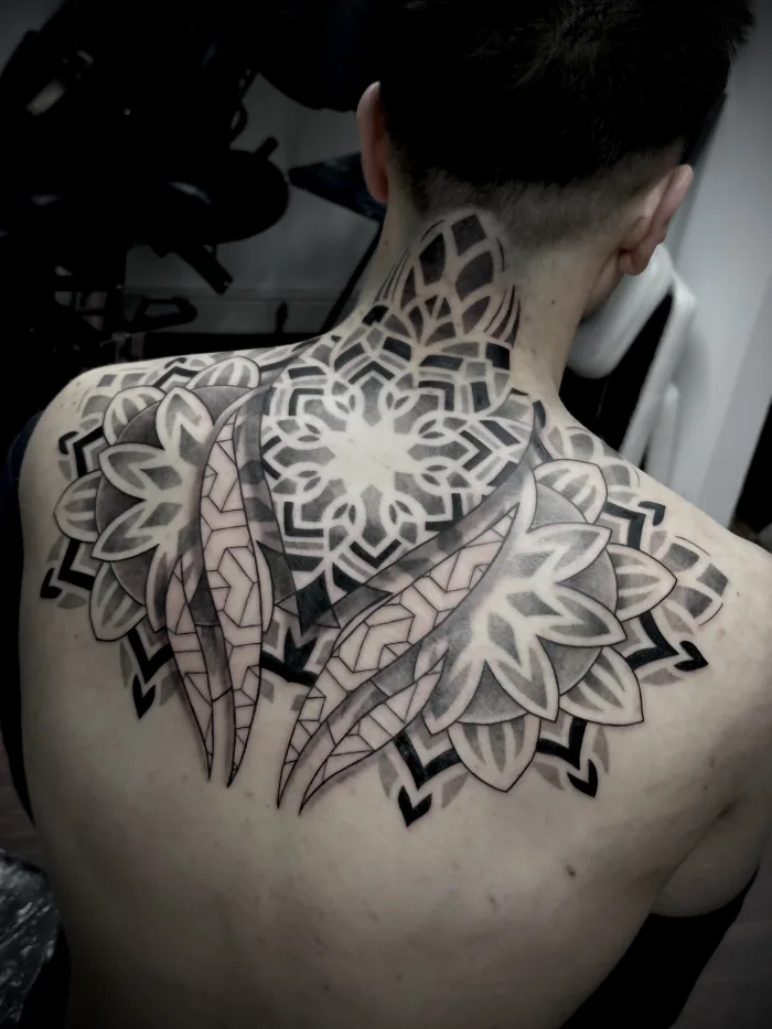 Large geometric mandala back tattoo with claw design in black and grey by Esther, Unicorn Tattoo Art Collective, Ashford Surrey