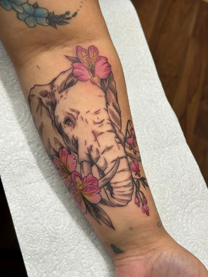 Custom black and grey half realism elephant tattoo done by Esther
