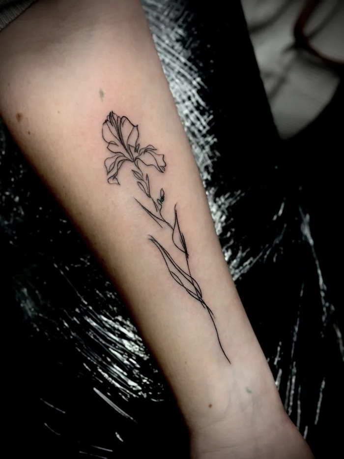 Fine line floral forearm tattoo minimalist black line Unicorn Tattoo Art Collective Ashford,Surrey