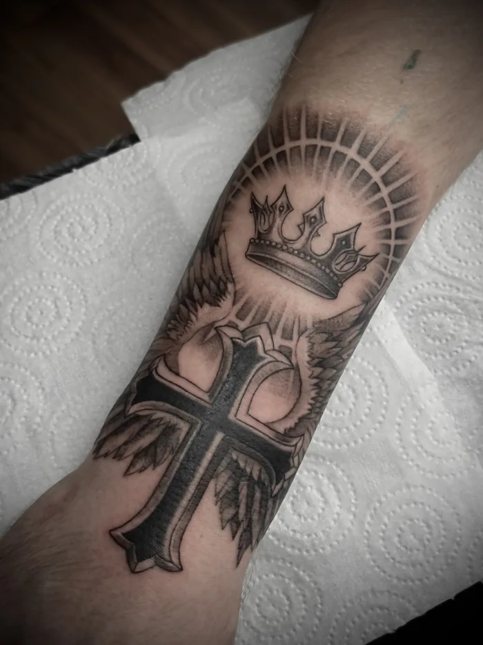 Religious Forearm Tattoo Cross Crown Wings Black and Grey Unicorn Tattoo Art Collective Ashford Surrey