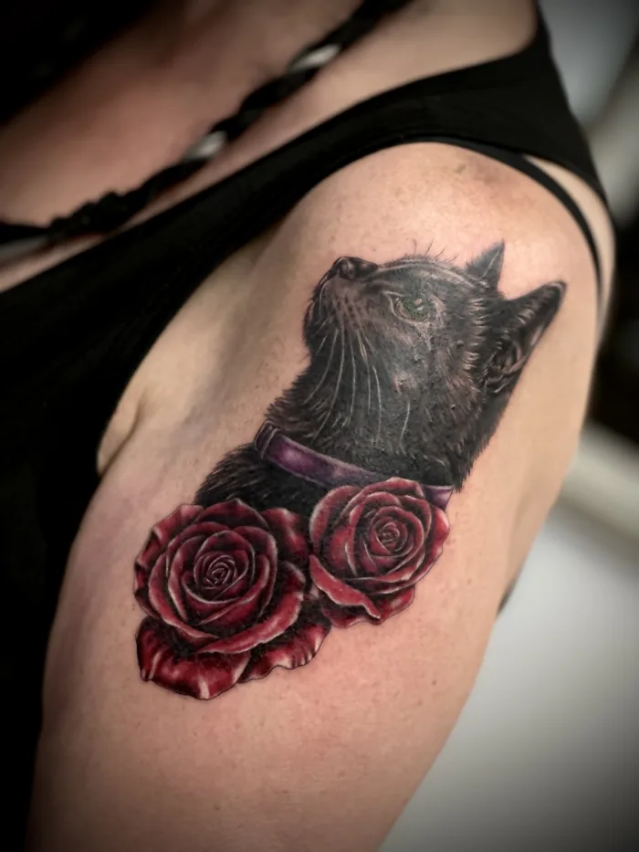 Black cat and red rose cover up tattoo by Esther at Unicorn Tattoo Art Collective Ashford Surrey