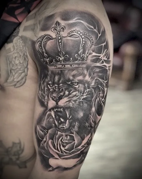 Healed black and grey lion tattoo with crown and rose by Esther in Ashford Surrey  Description: