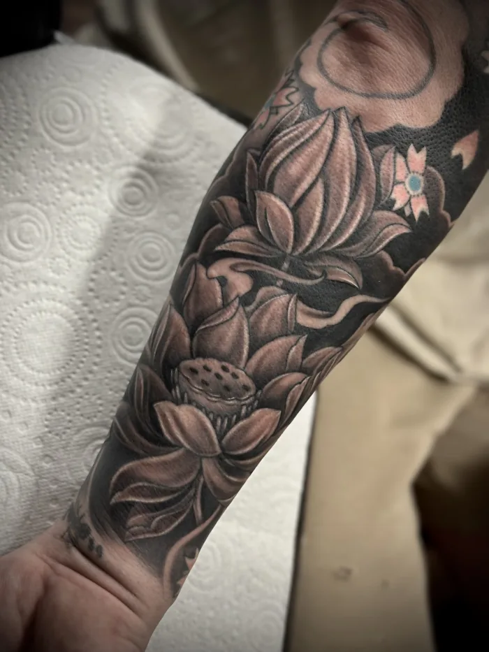 Black and grey lotus flower tattoo rework by Esther at Unicorn Tattoo Art Collective in Ashford, Surrey