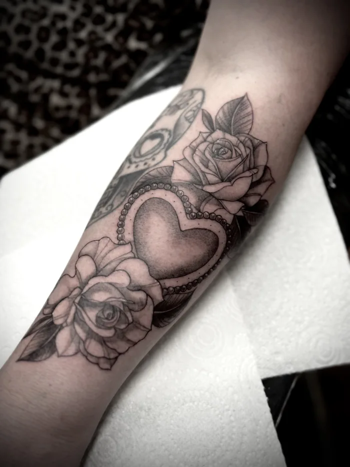 Black and grey rose and heart tattoo by Esther at Unicorn Tattoo Art Collective in Ashford, Surrey