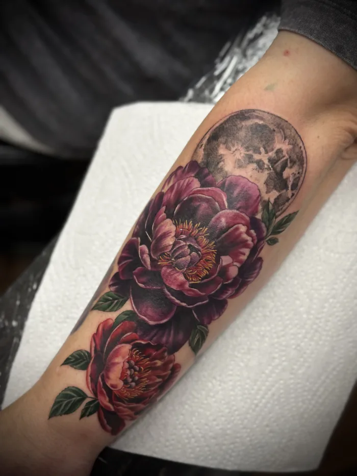 Colour realism floral tattoo with moon detail by Esther at Unicorn Tattoo Art Collective in Ashford, Surrey