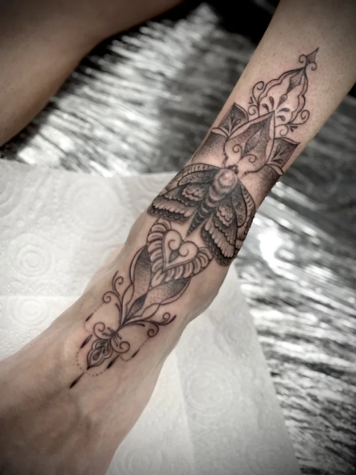 Mandala style leg tattoo with ornamental black and grey linework by Esther at Unicorn Tattoo Art Collective in Ashford, Surrey
