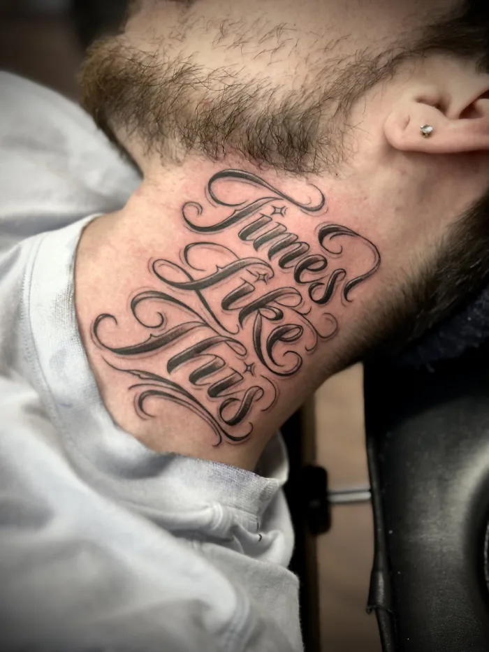 Neck lettering tattoo with script writing by Esther at Unicorn Tattoo Art Collective in Ashford, Surrey