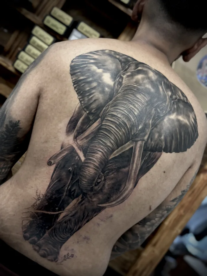Black and grey realistic back piece tattoo by Esther at Unicorn Tattoo Art Collective in Ashford, Surrey