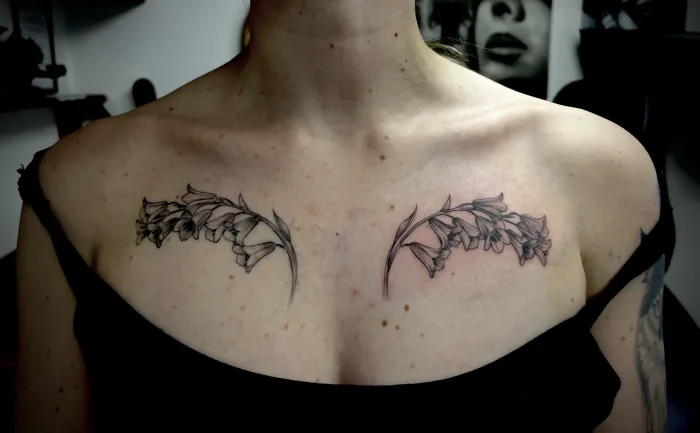 Symmetrical floral memorial chest tattoo by Esther at Unicorn Tattoo in Ashford, Surrey