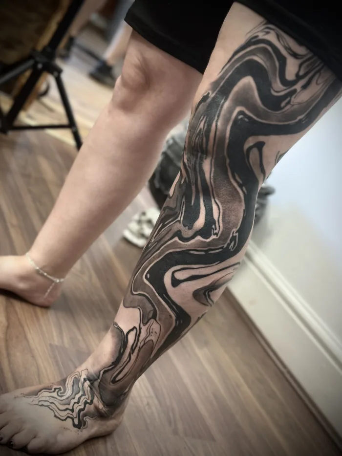Large-scale abstract blackwork leg sleeve in progress by Esther at Unicorn Tattoo Art Collective in Ashford, Surrey