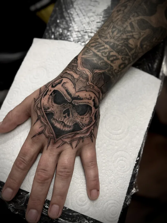 Black and grey skull hand tattoo by Esther at Unicorn Tattoo Art Collective in Ashford, Surrey